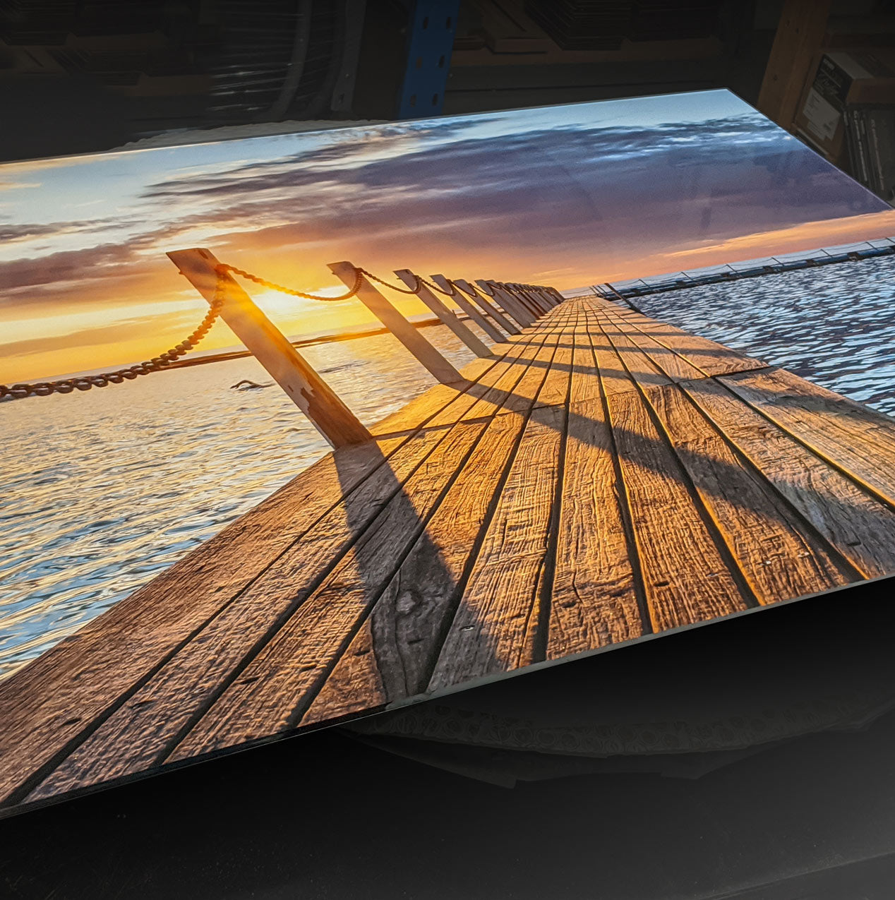 A sunrise photo print mounted to a sheet of acrylic 'glass'