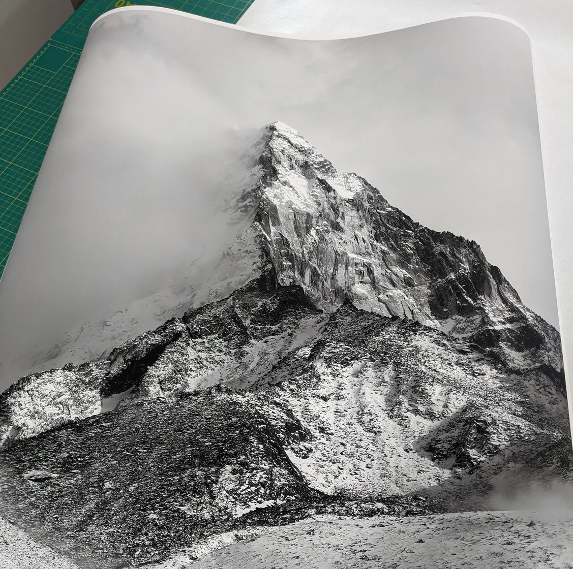 A black and white photo of a mountain printed on matte paper